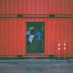 man holding umbrella inside the intermodal container