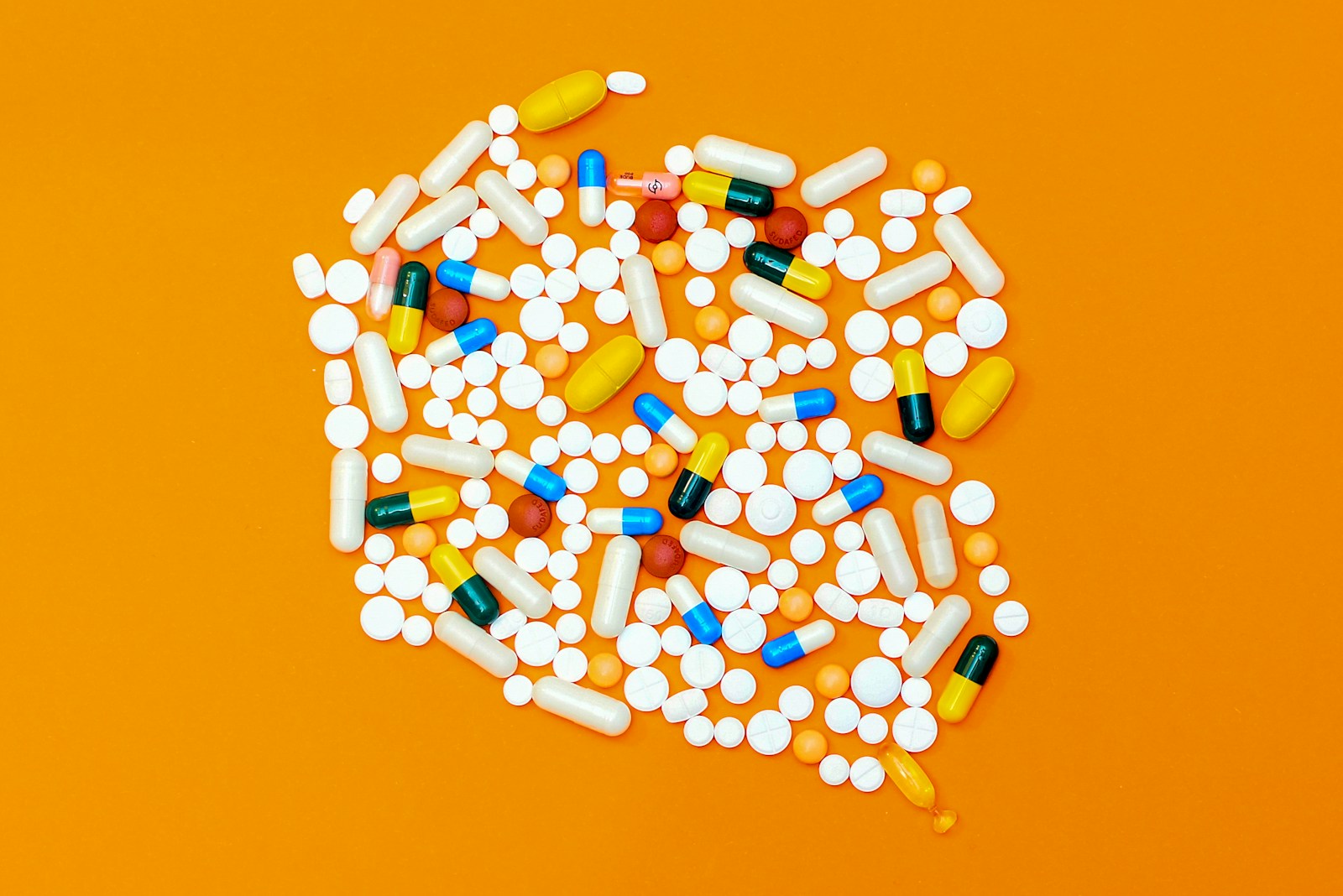 white and orange medication pill