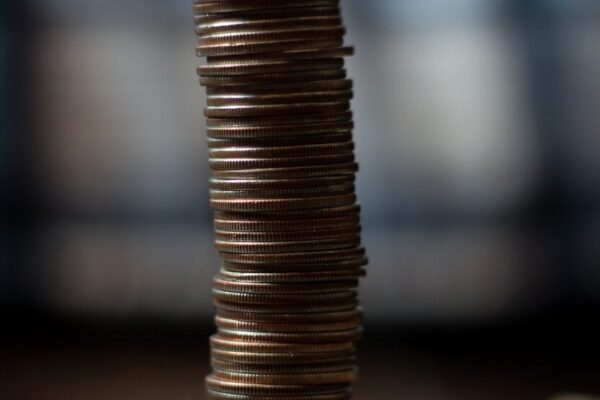 gold round coins on brown wooden table