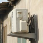 a white phone mounted to the side of a building