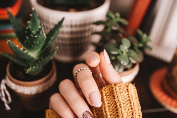 person holding brown woven basket